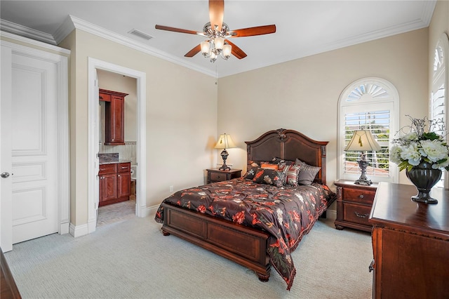 carpeted bedroom with ceiling fan, ornamental molding, and ensuite bathroom