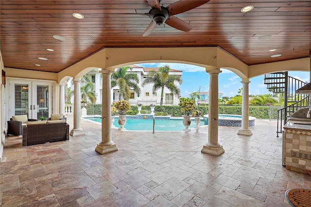 view of swimming pool with a patio area, pool water feature, and ceiling fan