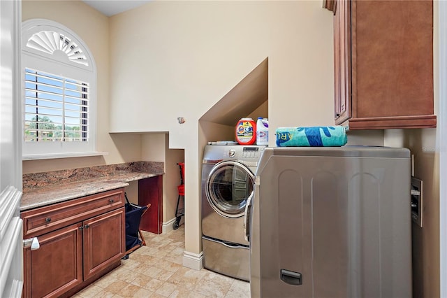 washroom with washing machine and dryer and cabinets