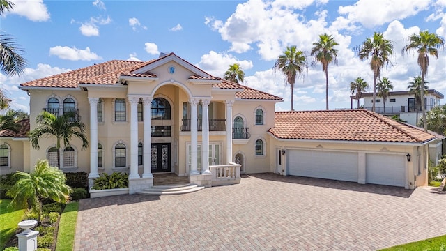 mediterranean / spanish-style home featuring a balcony and a garage