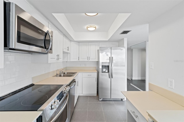 500 N Osceola Ave Unit 802, Clearwater, FL 33755 - kitchen featuring decorative backsplash, appliances with stainless steel finishes, a sink, light countertops, and white cabinets