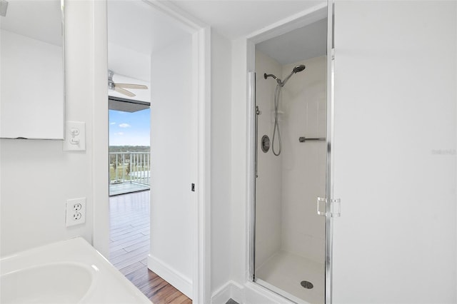 bathroom with walk in shower, vanity, wood-type flooring, and ceiling fan