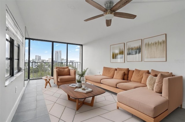 living room with ceiling fan, light tile patterned flooring, expansive windows, and a healthy amount of sunlight