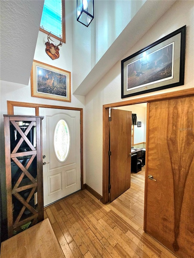 foyer with a textured ceiling and light wood-type flooring