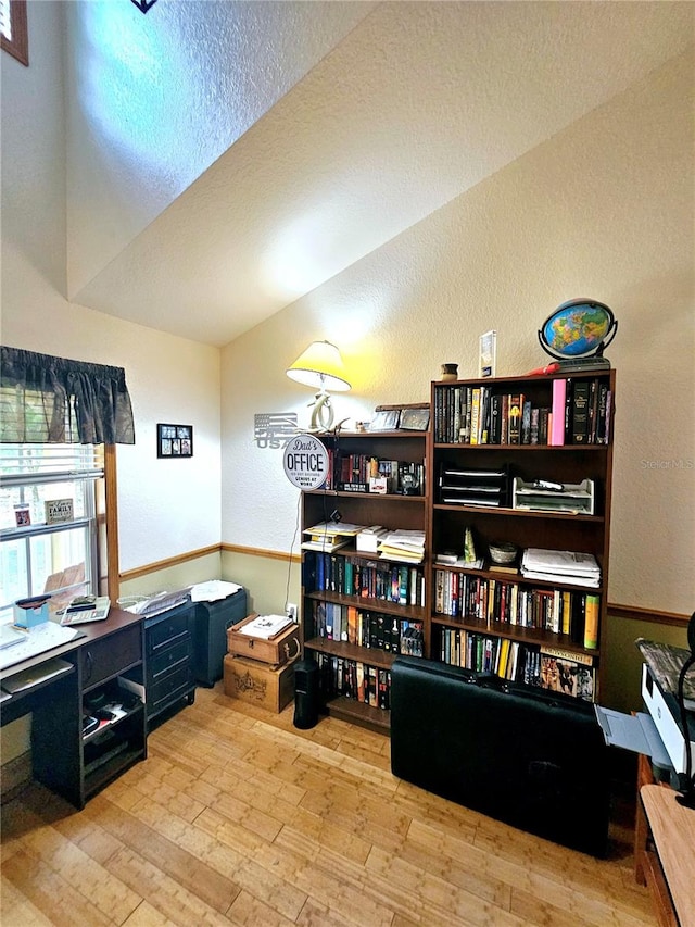 home office featuring a textured ceiling and light wood-type flooring