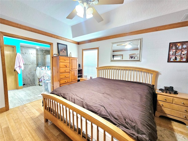 bedroom with light hardwood / wood-style flooring, a textured ceiling, and ceiling fan