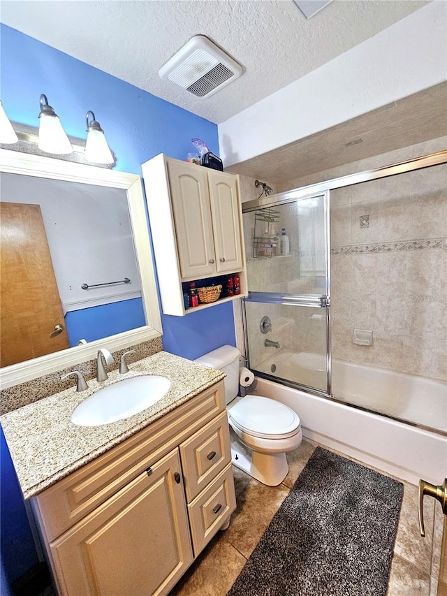 full bathroom with a textured ceiling, shower / bath combination with glass door, toilet, vanity, and tile patterned floors