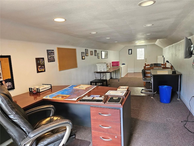 carpeted home office featuring a textured ceiling and lofted ceiling