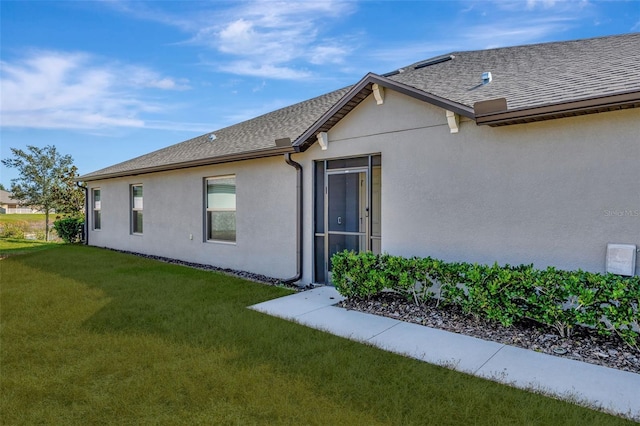 view of side of property with a yard