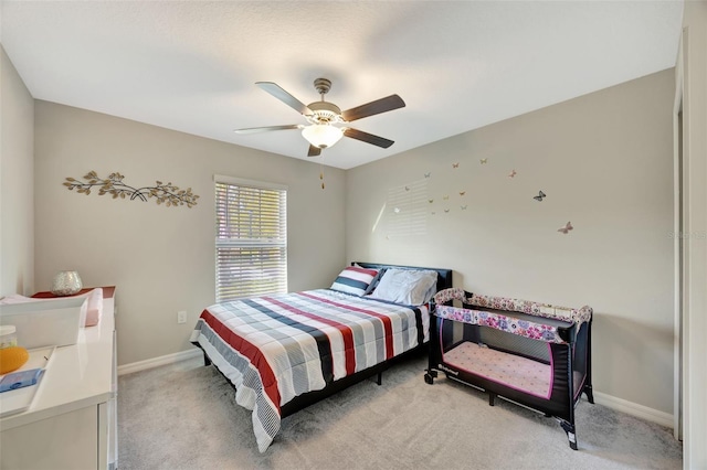 bedroom featuring light colored carpet and ceiling fan