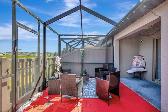 view of patio featuring a lanai