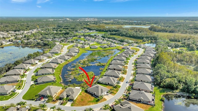 birds eye view of property with a water view