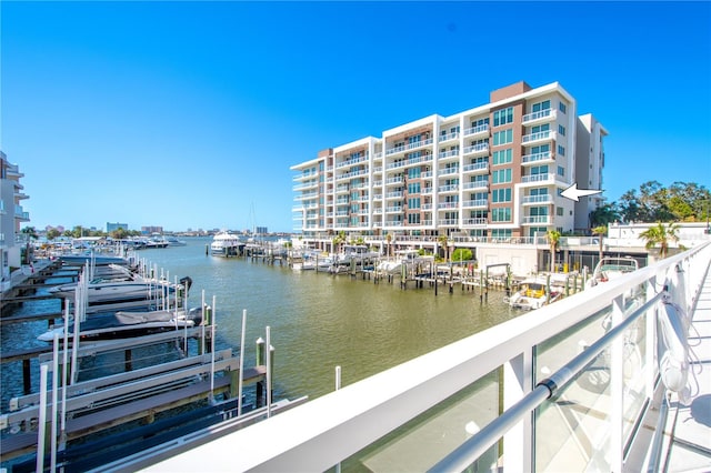 view of dock featuring a water view and a balcony