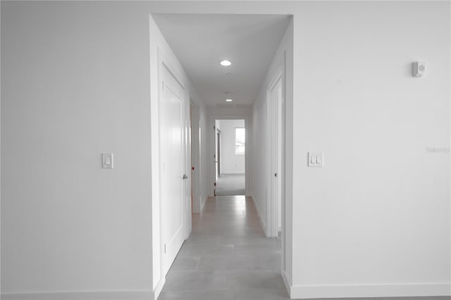 hall with light tile patterned floors