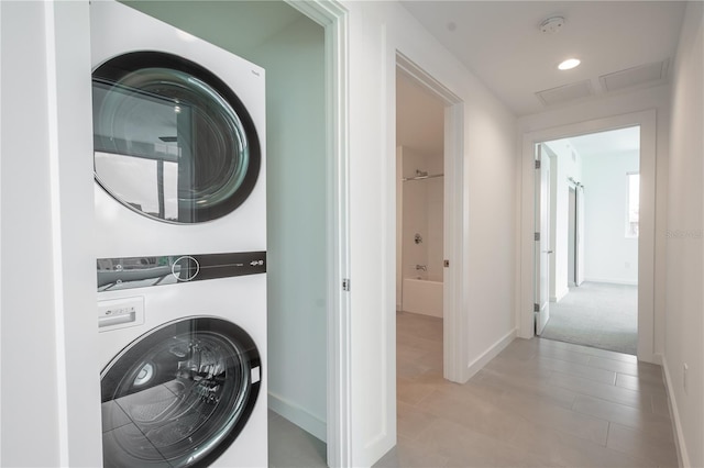 laundry room featuring stacked washing maching and dryer