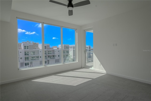 carpeted empty room featuring ceiling fan