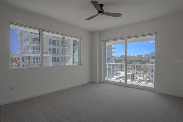 unfurnished room with carpet and ceiling fan