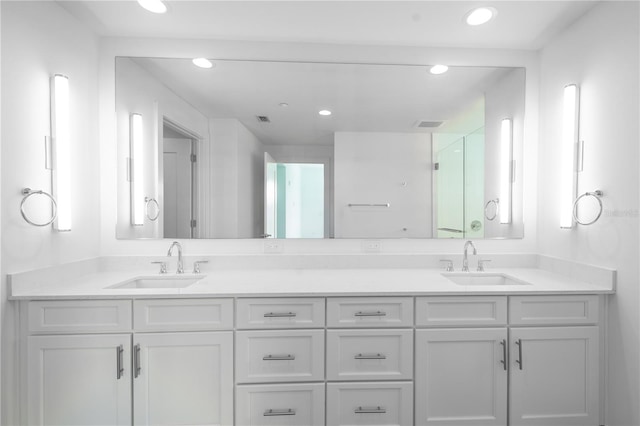 bathroom with vanity and a shower with shower door