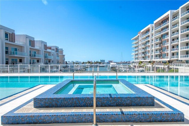 view of swimming pool featuring a hot tub