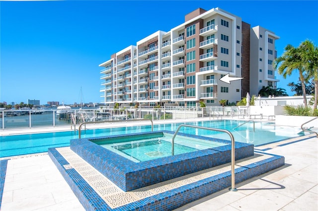 view of swimming pool featuring a community hot tub