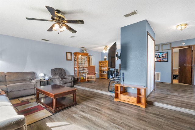 living room with ceiling fan and wood-type flooring