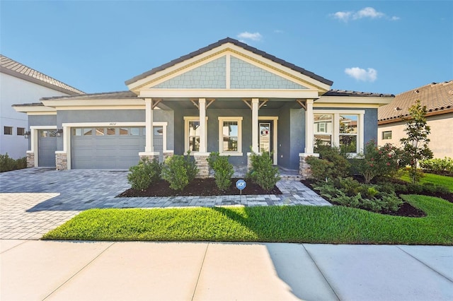 craftsman-style house with covered porch and a garage