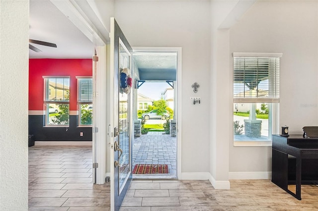 entryway featuring ceiling fan, light hardwood / wood-style flooring, and plenty of natural light