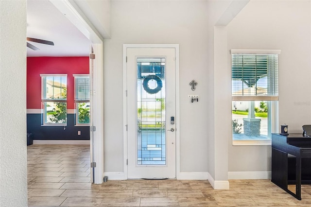 foyer entrance with light wood-type flooring and ceiling fan