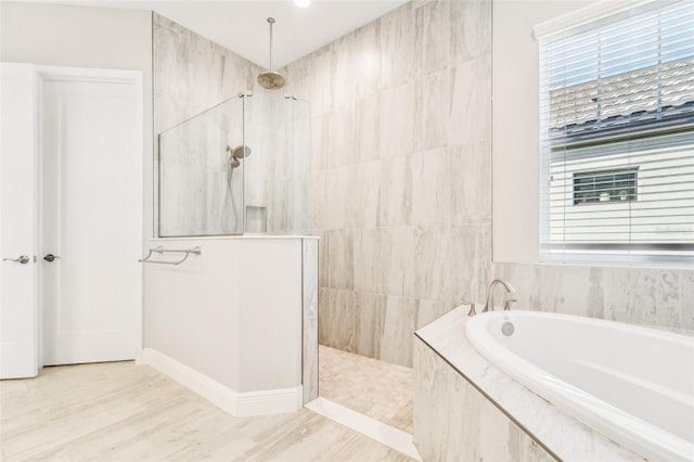 bathroom with hardwood / wood-style flooring and independent shower and bath