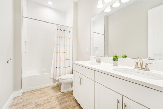 full bathroom with vanity, toilet, hardwood / wood-style flooring, and shower / bath combo with shower curtain