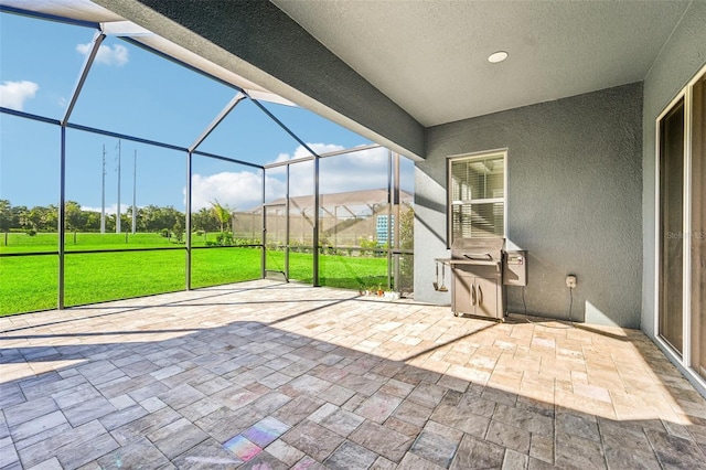 view of patio / terrace featuring glass enclosure