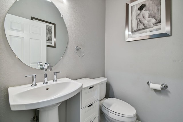 bathroom with toilet and sink