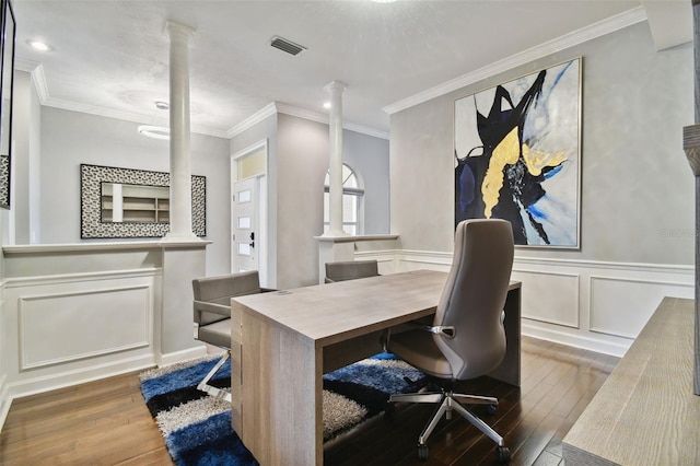 home office with dark wood-type flooring, ornamental molding, and decorative columns