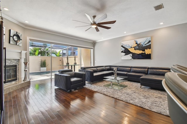 living room with dark wood-type flooring, crown molding, a textured ceiling, and ceiling fan