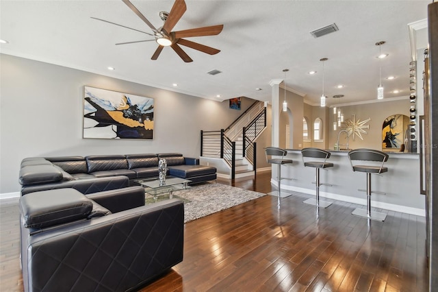 living room featuring crown molding, ceiling fan, sink, and dark hardwood / wood-style flooring