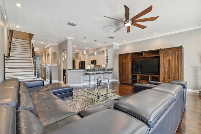 living room with crown molding, ceiling fan, and dark hardwood / wood-style flooring