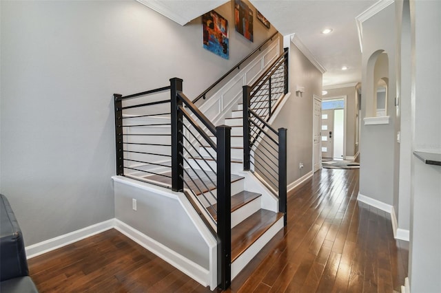 stairs featuring ornamental molding and hardwood / wood-style flooring