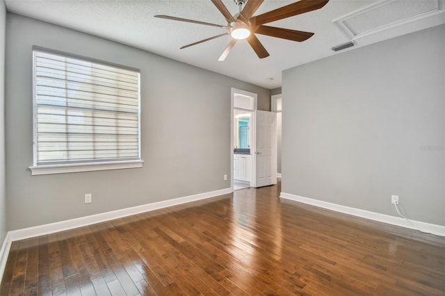 spare room with dark hardwood / wood-style floors, a textured ceiling, and ceiling fan