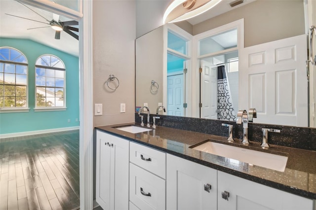 bathroom featuring vanity, vaulted ceiling, wood-type flooring, and ceiling fan