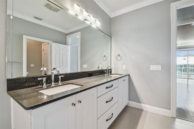 bathroom with vanity, crown molding, and tile patterned flooring