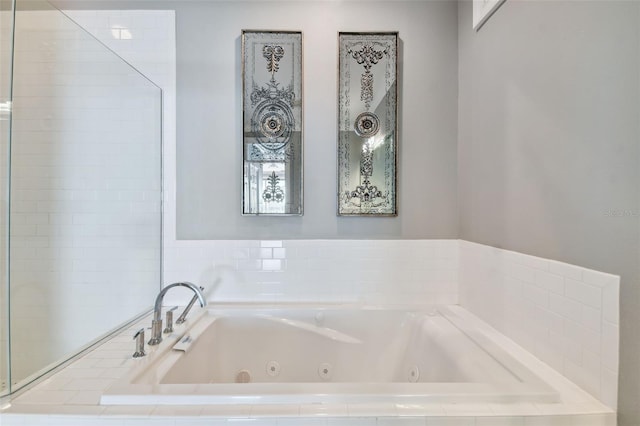 bathroom with a relaxing tiled tub