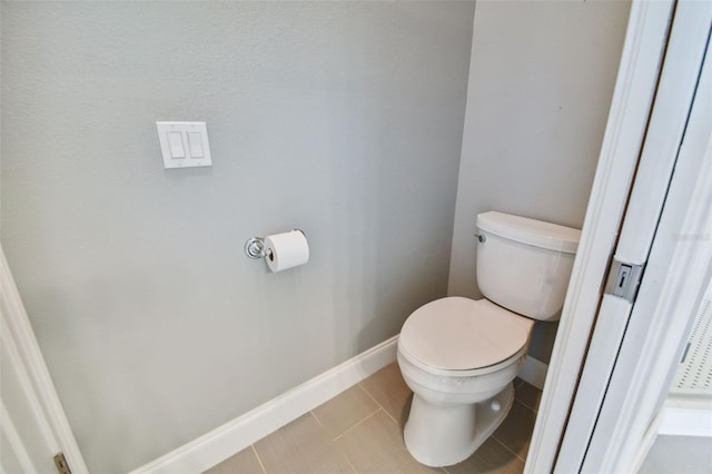 bathroom with toilet and tile patterned floors