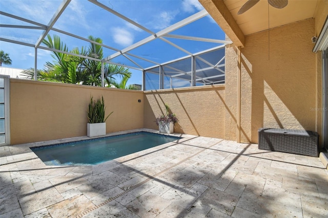 view of pool with a patio, a lanai, and ceiling fan