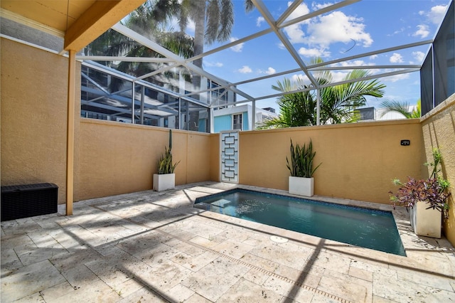 view of pool featuring a patio area and glass enclosure