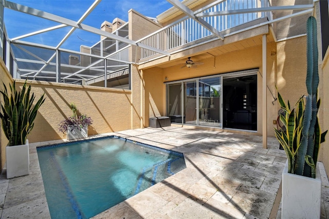 view of pool featuring a patio, ceiling fan, and a lanai