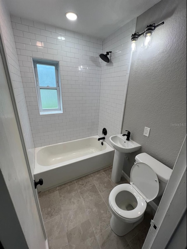 full bathroom with sink, toilet, and tiled shower / bath