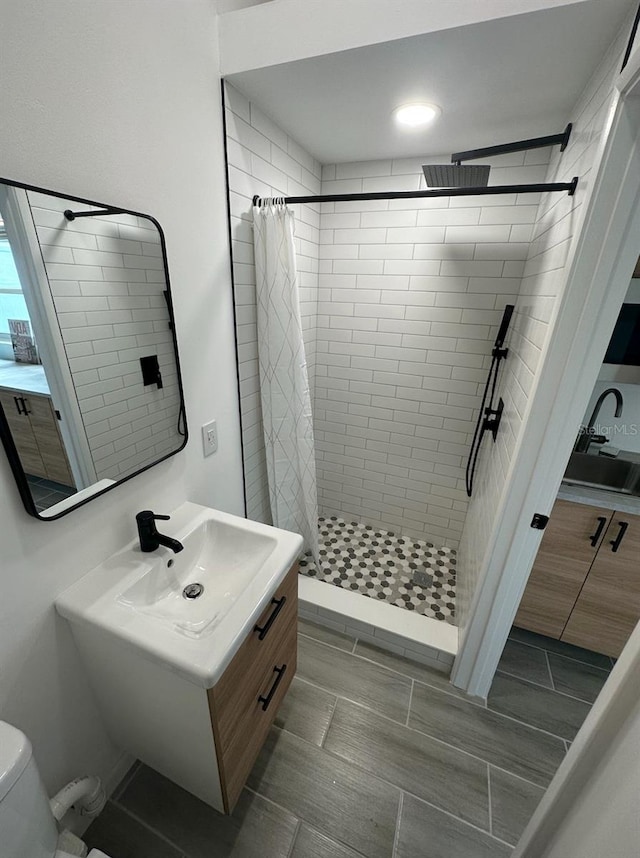 bathroom with vanity, toilet, and curtained shower