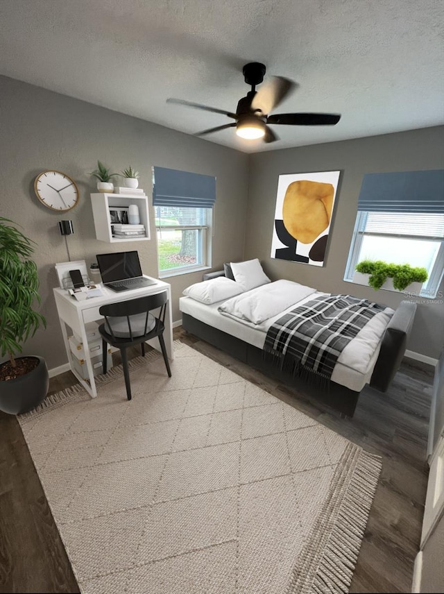 bedroom with wood-type flooring, a textured ceiling, and ceiling fan