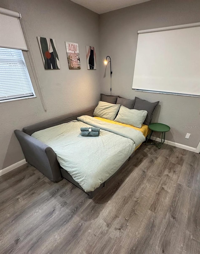 bedroom with hardwood / wood-style flooring