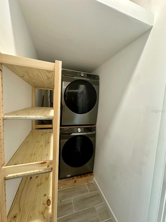 clothes washing area featuring stacked washer and clothes dryer